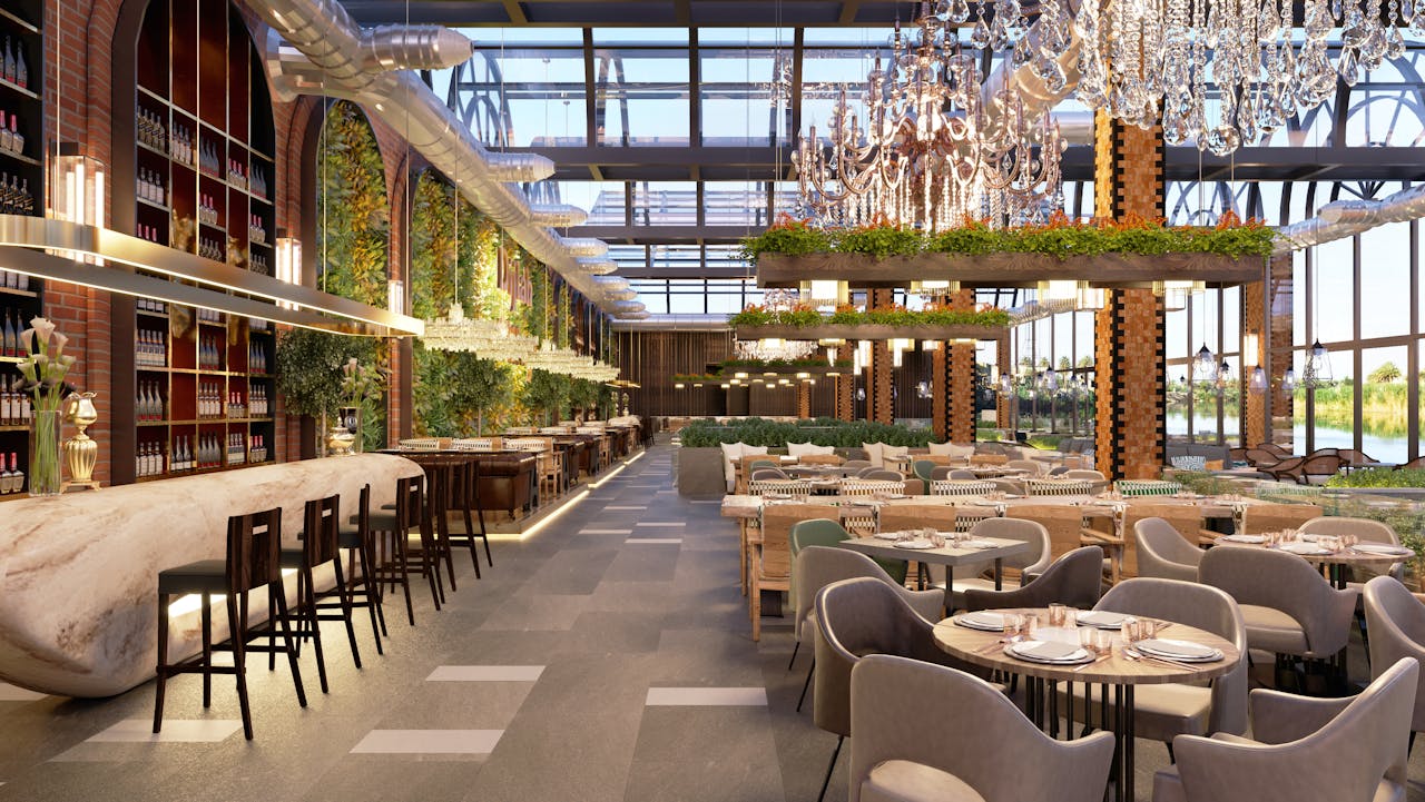 Elegant restaurant interior featuring chandeliers, greenery, and stylish dining furnishings.